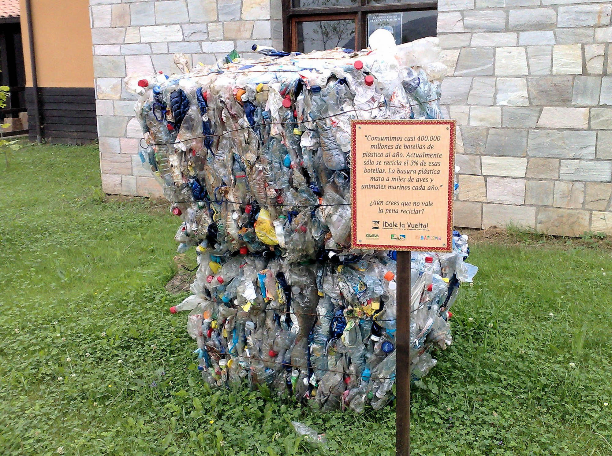 Car battery with green recycle sign.