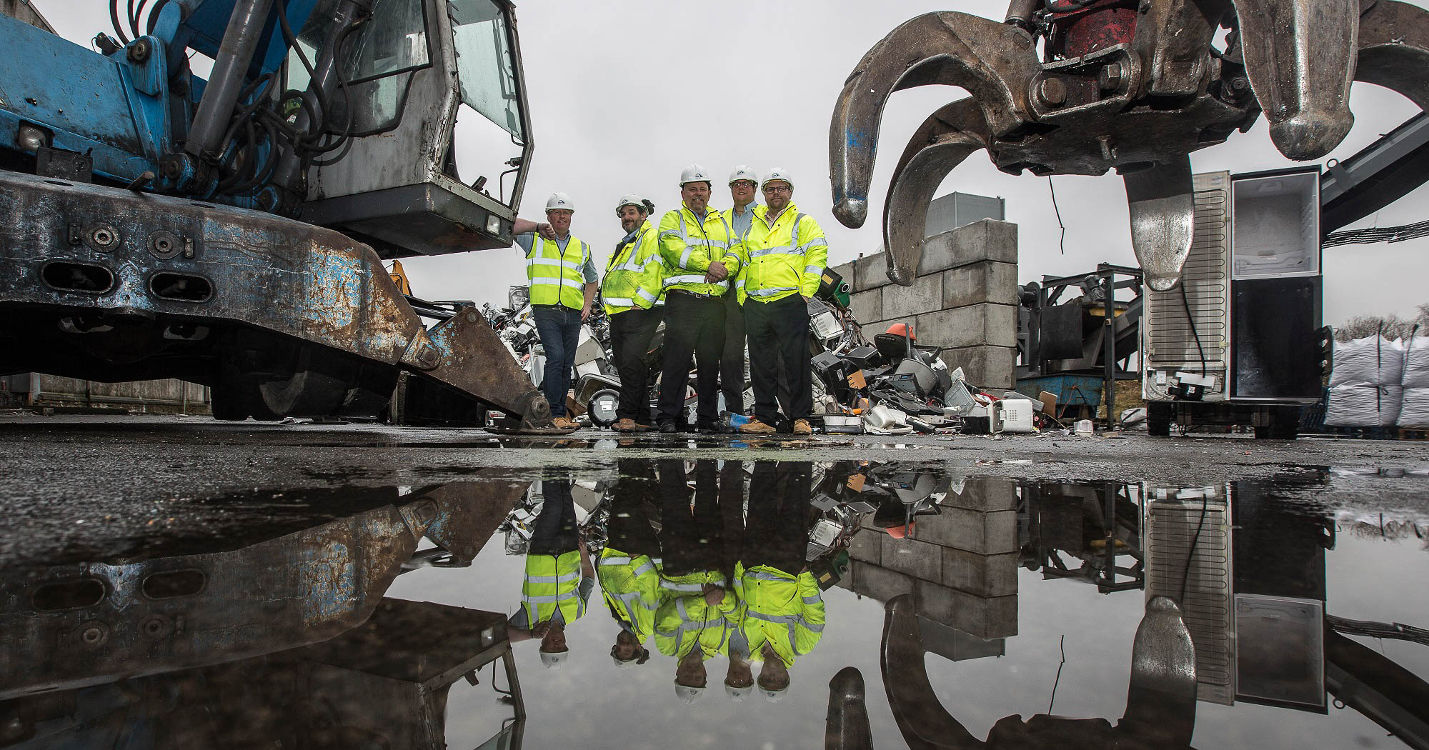 Car battery with green recycle sign.