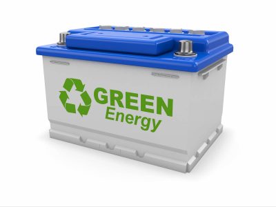 Car battery with green recycle sign.