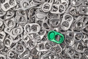 Recycling aluminum background with pull-tab pieces. Metallic waste