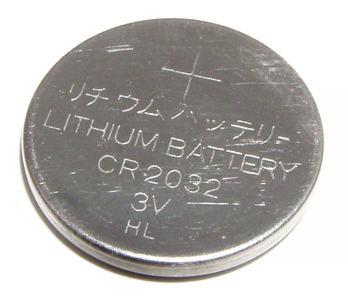 Car battery with green recycle sign.